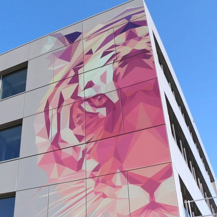 Wall of the TIGER headquarters building in Austria showing a tiger printed onto the right of the facade